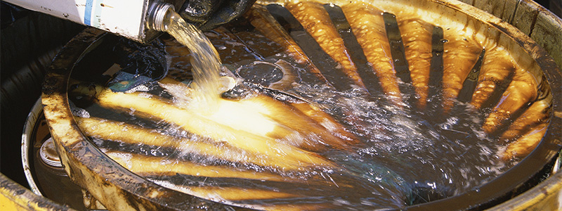 pouring chemicals into a drum